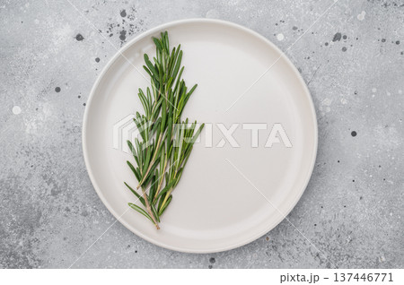 White empty plate with green rosemary garnish on neutral background. Modern food presentation with copy space White empty plate with green rosemary garnish on neutral background. Modern food presentation with copy space 137446771