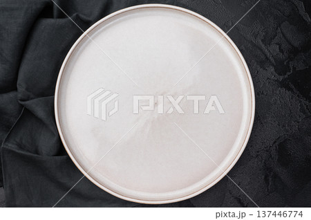 Minimal empty plate on dark background with texture. Modern ceramic tableware mockup with copy space 137446774