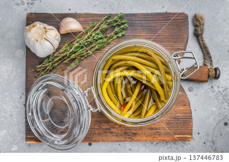 Pickled ramsons in glass jar on wooden board rustic background wild garlic preserve fermented spring greens Pickled ramsons in glass jar on wooden board rustic background wild garlic preserve fermented spring greens 137446783