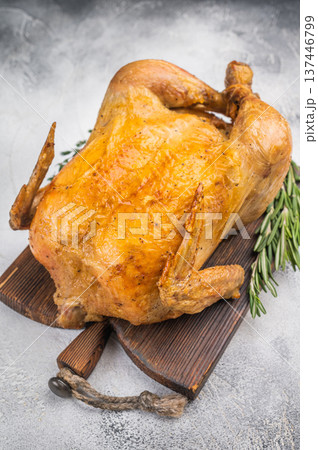 Traditional roast chicken baked until juicy and golden served on cutting board with herbs. Rustic food photography with copy space Traditional roast chicken baked until juicy and golden served on cutting board with herbs. Rustic food photography with copy space 137446799