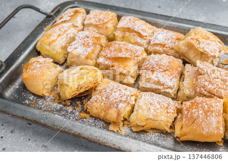 Traditional bougatsa Greek custard pastry with creamy milk filling flaky filo layers and powdered sugar bakery dessert 137446806