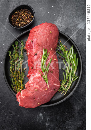Fresh raw beef meat with rosemary and thyme prepared for roasting. High quality protein for homemade roast beef and gourmet dishes. Fresh raw beef meat with rosemary and thyme prepared for roasting. High quality protein for homemade roast beef and gourmet dishes. 137446819
