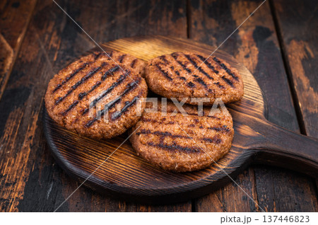 Vegetarian grilled burger patties plant based meat substitute high protein cruelty free food rustic dark background Vegetarian grilled burger patties plant based meat substitute high protein cruelty free food rustic dark background 137446823