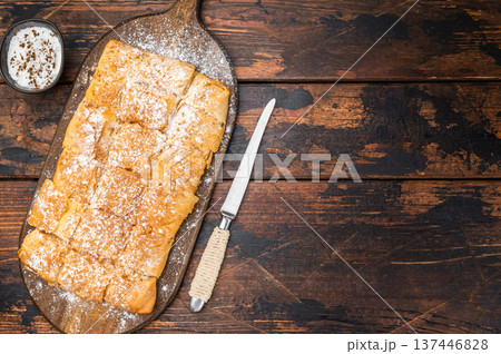 Milk pie custard pastry made of crispy filo layers sliced and served as breakfast or dessert on wooden board. Milk pie custard pastry made of crispy filo layers sliced and served as breakfast or dessert on wooden board. 137446828