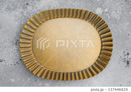 Antique style oval brass plate overhead. Decorative metal tableware with copy space 137446829