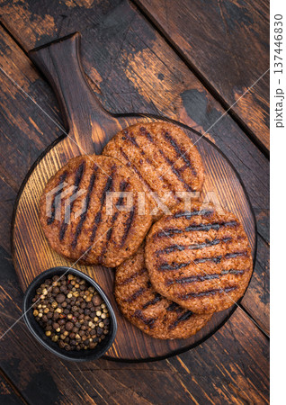 Vegetarian grilled burger patties plant based meat substitute high protein cruelty free food rustic dark background 137446830