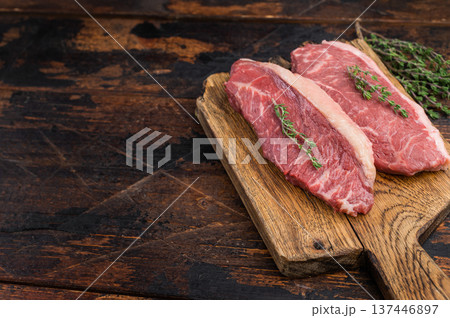 Uncooked picanha also called culotte or top sirloin cap, marbled beef steak with fat cap, rustic presentation on wooden board Uncooked picanha also called culotte or top sirloin cap, marbled beef steak with fat cap, rustic presentation on wooden board 137446897