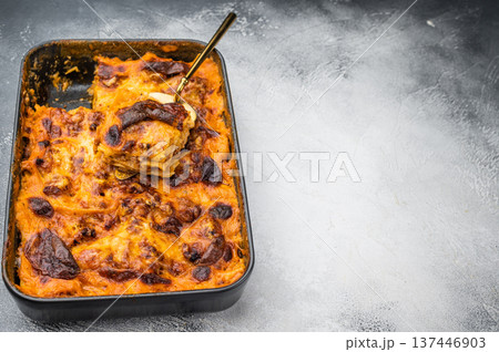 Italian lasagne al forno with beef meat sauce and golden cheese crust in casserole pan overhead flat lay Italian lasagne al forno with beef meat sauce and golden cheese crust in casserole pan overhead flat lay 137446903