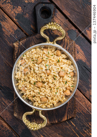 Healthy vegan bulgur pilaf with chickpeas Turkish cuisine served on wooden board top view rustic style 137446904