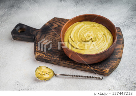 Sweet pistachio cream spread with rich green color served in wooden bowl flat lay minimal food styling with copy space 137447218