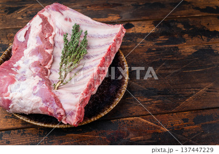 Raw pork spareribs rack with knife and herbs flat lay premium meat ingredient for roasting smoking and grill cooking Raw pork spareribs rack with knife and herbs flat lay premium meat ingredient for roasting smoking and grill cooking 137447229