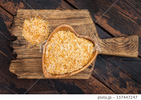Shredded phyllo kataifi dough used for sweet pastries and desserts. Rustic overhead composition with copy space Shredded phyllo kataifi dough used for sweet pastries and desserts. Rustic overhead composition with copy space 137447247