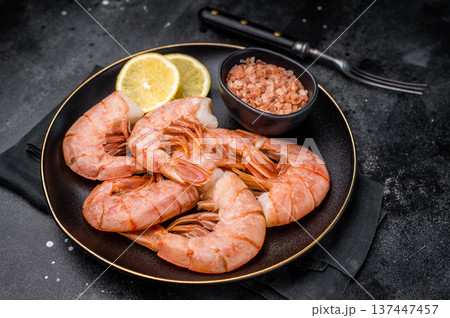 Uncooked Headless Red shrimps, raw Prawns on plate. black background. top view 137447457
