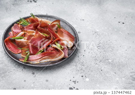 Meat appetizer dried duck breast fillet meat slices, magret smoked poultry. grey background. top view Meat appetizer dried duck breast fillet meat slices, magret smoked poultry. grey background. top view 137447462