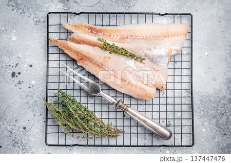 Raw pollock white fish fillet with thyme. grey background. top view 137447476