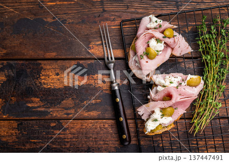 Italian sandwich Bruschetta with Prosciutto Cotto ham, burrata mozzarella and olives. wooden background. top view Italian sandwich Bruschetta with Prosciutto Cotto ham, burrata mozzarella and olives. wooden background. top view 137447491