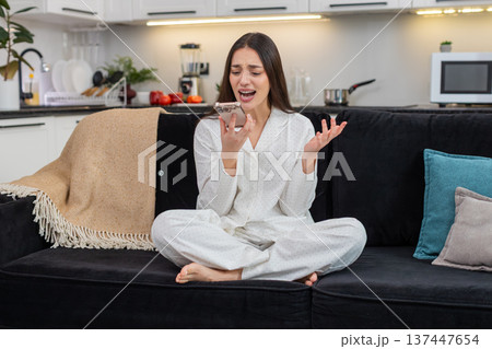 Young woman argues on speakerphone frowns talk with hands says what why explains point ends call mad 137447654
