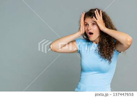 Young amazed woman surprised mouth open amazed astonished reaction unexpected wow facial expression Young amazed woman surprised mouth open amazed astonished reaction unexpected wow facial expression 137447658