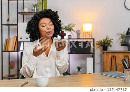 African American businesswoman on smartphone speaker gesturing happy explaining successful project African American businesswoman on smartphone speaker gesturing happy explaining successful project 137447737