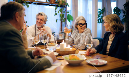 Senior friends enjoying dinner party at home 137448432