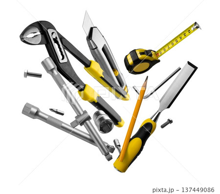 Collection of hardware on plain background. Diverse array of hand tools including screwdrivers and wrenches arranged for retail presentation 137449086