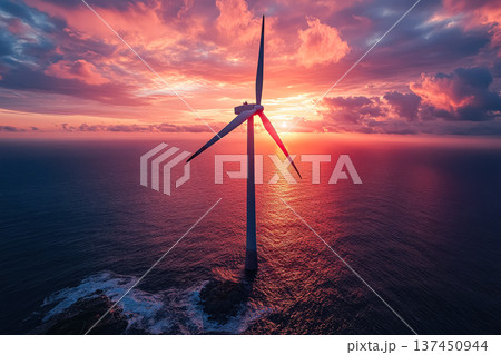 Wind turbine is seen in the sky above the ocean 137450944