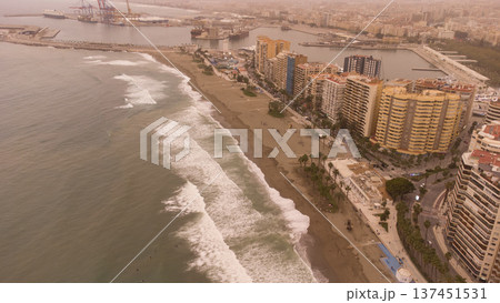 Spanish Coastal Cityscape Engulfed in Dramatic Moroccan Sandstorm, Featuring Urban Beach, Tall Buildings, and Bustling PortSpain in sandstorm from Moroco 137451531