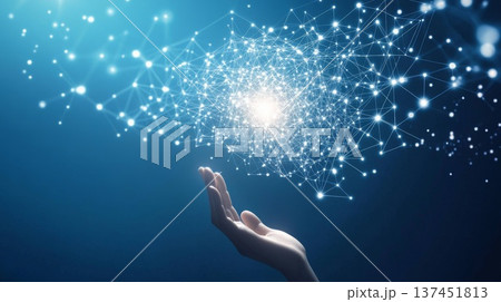 A hand reaches out to touch a luminous sphere of interconnected dots in a darkened atmosphere. A hand reaches out to touch a luminous sphere of interconnected dots in a darkened atmosphere. 137451813