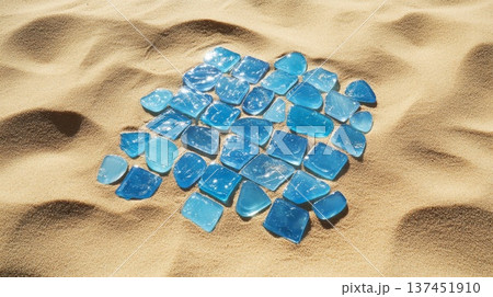 A Beautiful Pile of Blue Sea Glass Shimmering Under the Warm Sunlight on a Sandy Beach 137451910
