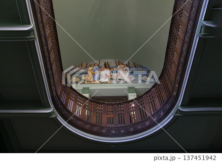 This upward-looking perspective highlights the neoclassical and colonial influences of the Bang Khun Phrom Palace interior. The composition is centered on a semi-circular mezzanine balcony featuring a 137451942