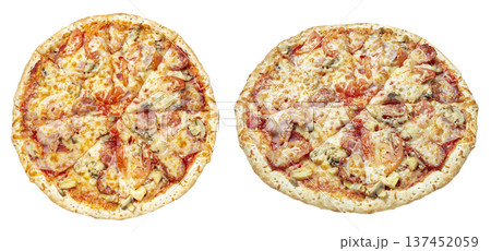 Top view of two delicious freshly baked pizzas with melted cheese, tomato slices, ham, and mushrooms 137452059