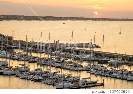 Sunset coast. Seaport of the Italian city of Rimini in Summer Italy Sunset coast. Seaport of the Italian city of Rimini in Summer Italy 137453690