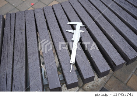 Caliper metal tool on wooden background 137453743