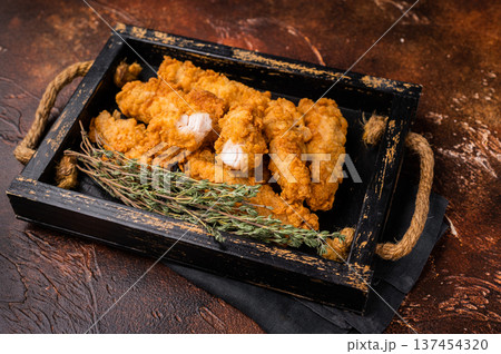 Homemade Deep Fried chicken tenders or strips. brown background. top view 137454320