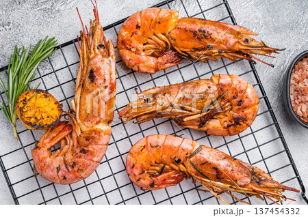 Seafood BBQ with Grilled red Argentine shrimps, Prawns Langostino Austral on a rack with herbs. grey background. top view Seafood BBQ with Grilled red Argentine shrimps, Prawns Langostino Austral on a rack with herbs. grey background. top view 137454332