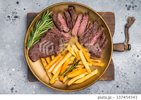 BBQ Grilled Beef Skirt Machete Steak on a plate with french fries grey background. top view 137454341