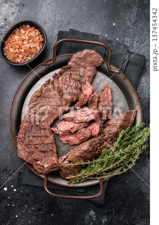 Grilled Beef Machete Skirt Steak, prime meat. black background. top view Grilled Beef Machete Skirt Steak, prime meat. black background. top view 137454342
