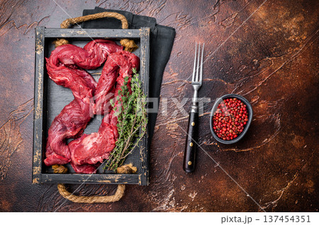 Beef cut Machete Skirt Steak, raw marble meat in wooden tray. black background. top view 137454351