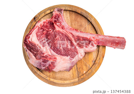 Uncooked tomahawk steak, raw black angus beef rib eye with bone on wooden board Isolated on a white background. top view 137454388