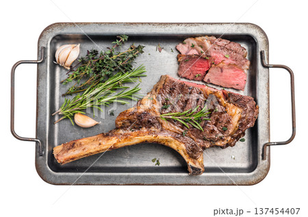 BBQ cooked Tomahawk beef steak, prime ribeye with bone on tray with herbs isolated on white background. top view 137454407