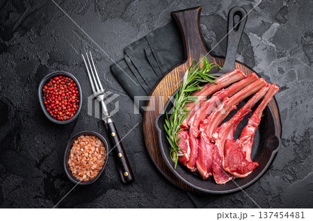 Ready for cooking Raw lamb meat chops, fresh mutton cutlets in a pan. black background. top view Ready for cooking Raw lamb meat chops, fresh mutton cutlets in a pan. black background. top view 137454481