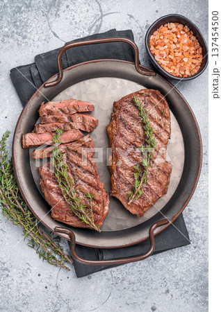 Roast Top blade steak, grilled beef shoulder meat. grey background. top view 137454500