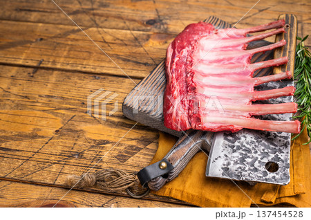 Butcher board with Raw lamb meat for chops steaks, fresh rack of mutton. wooden background. top view 137454528