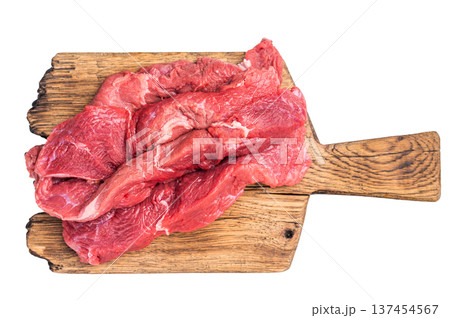 Beautifully arranged raw horse meat slices on a wooden platter, showcasing its appealing color and texture, perfect for cooking inspiration. isolated on white background. top view Beautifully arranged raw horse meat slices on a wooden platter, showcasing its appealing color and texture, perfect for cooking inspiration. isolated on white background. top view 137454567