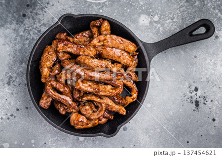Delicious glazed teriyaki beef in a skillet. grey background. top view 137454621