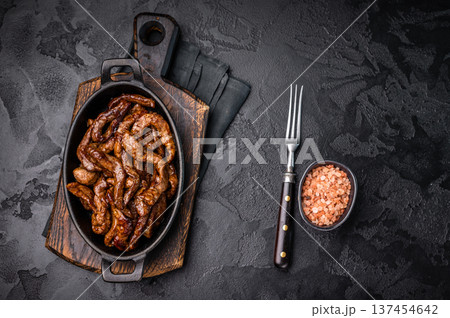 Korean Beef Meat Bulgogi Hot Plate. black background. top view 137454642