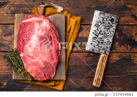 Fresh raw boneless beef shank displayed on a wooden cutting board, showcasing its rich color and marbling, perfect for hearty soups and stews. wooden background. top view Fresh raw boneless beef shank displayed on a wooden cutting board, showcasing its rich color and marbling, perfect for hearty soups and stews. wooden background. top view 137454661