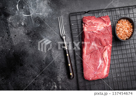 Close-up of raw horse meat, emphasizing its quality and freshness, ready to be transformed into exquisite dishes for adventurous palates. black background. top view 137454674