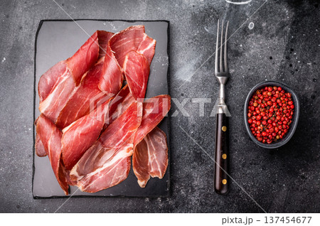 Sliced prsut prshut, Balkan cured pork meat ham. black background. top view 137454677