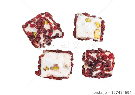 White pistachio lokum covered with dried cranberries. Gourmet jelly candy photographed from above, isolated. 137454694